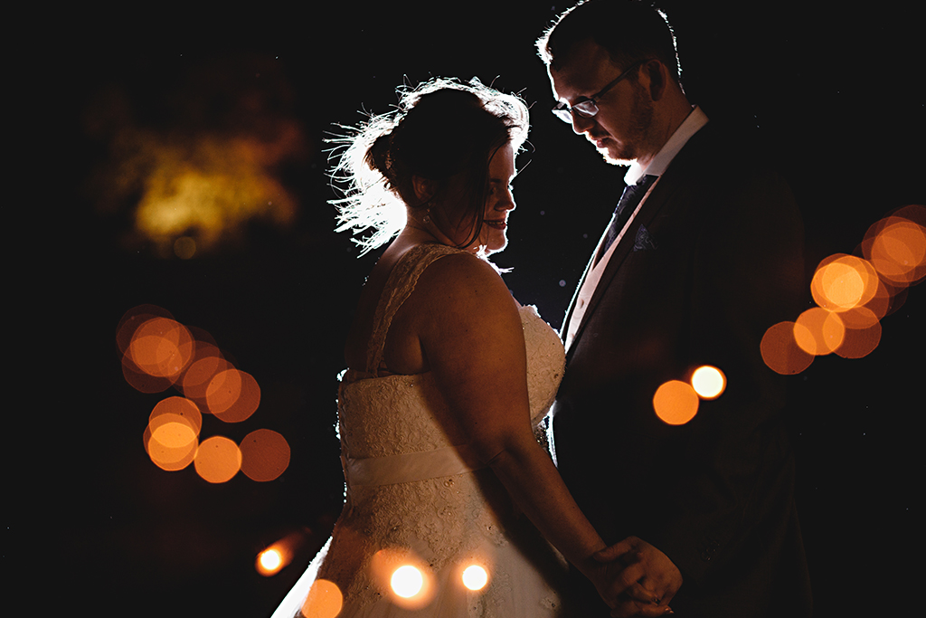 The bride and groom steal a moment at their wedding evening at Sandhole Oak Barn
