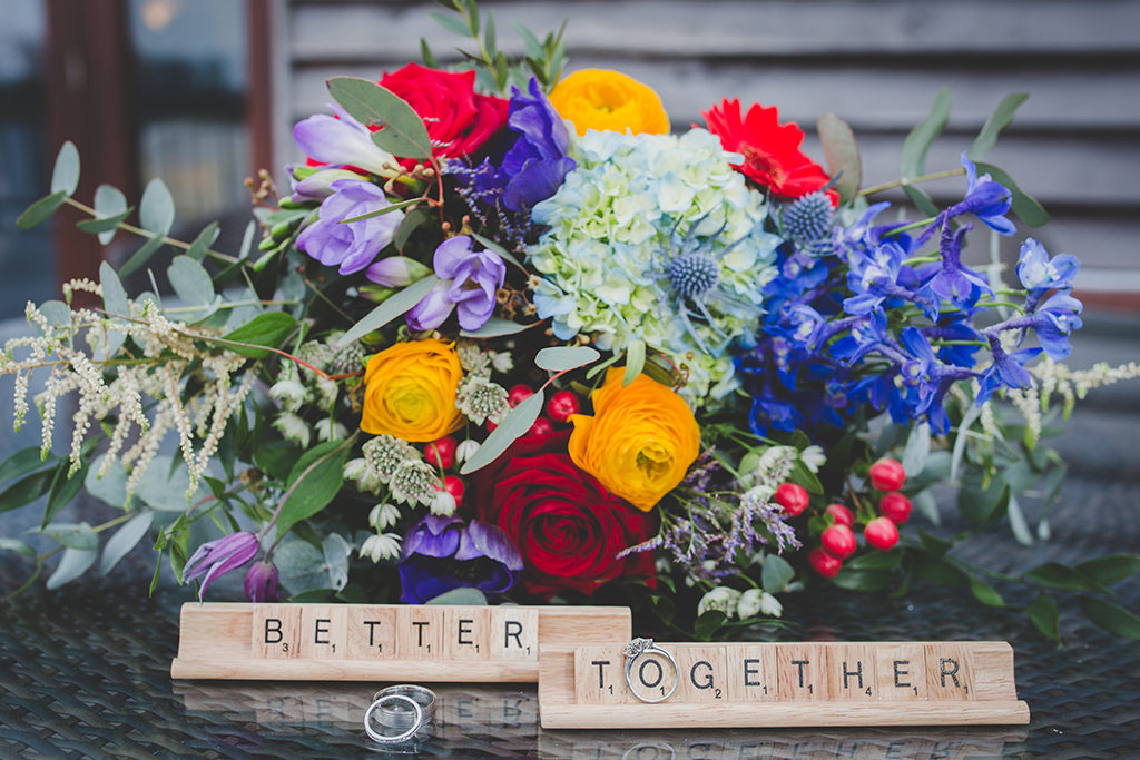 The wedding flowers were a stunning mix of beautifully bright coloured blooms and lush foliage at this barn wedding in Cheshire