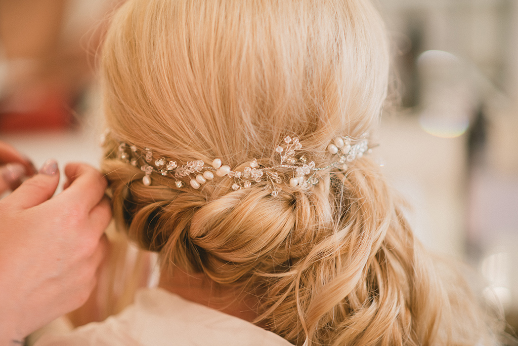The bride enjoys her bridal preparations as she has her wedding hair done in the stylish wedding accommodation