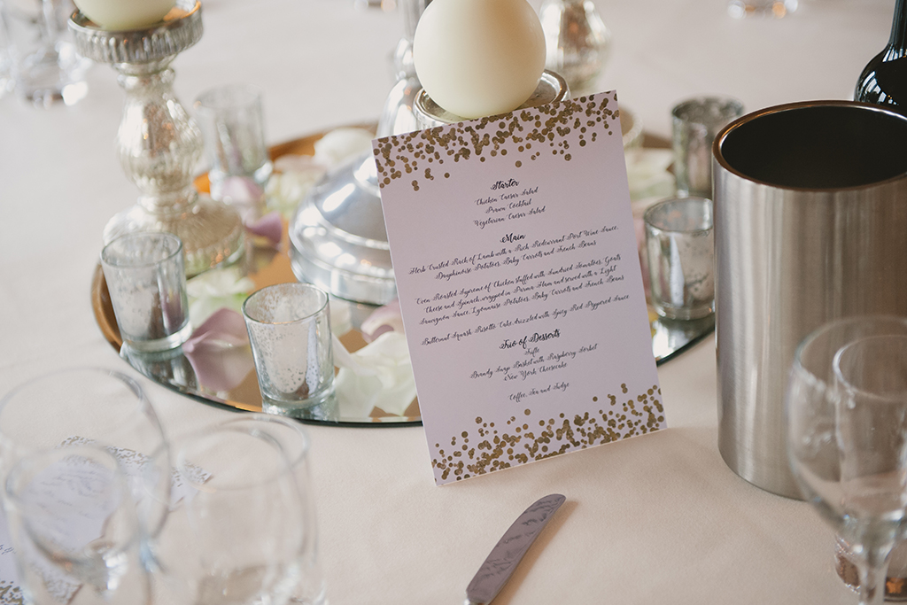 The wedding breakfast menu was displayed on a white card decorated with gold foil confetti – wedding ideas