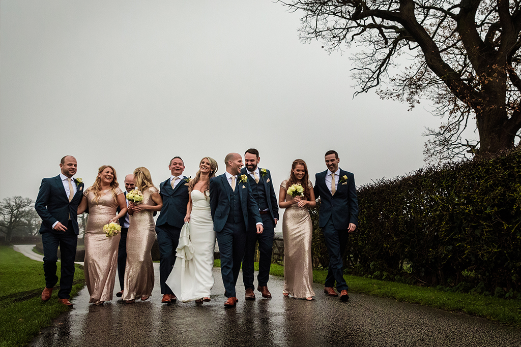 Metallic pink bridesmaid dresses and navy woollen three-piece suits contrast beautifully at this rustic winter wedding at Sandhole Oak Barn in rural Cheshire