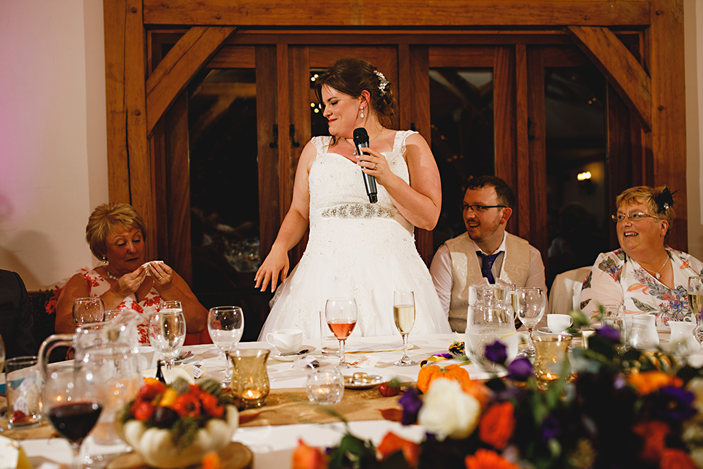 The bride makes a speech at her wedding at Sandhole Oak Barn in Cheshire