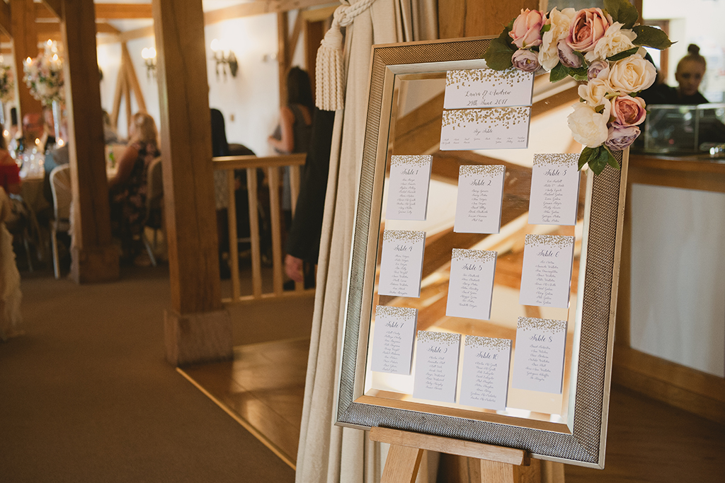 The couple’s stylish wedding table plan was presented on a mirror directing wedding guests to their seats