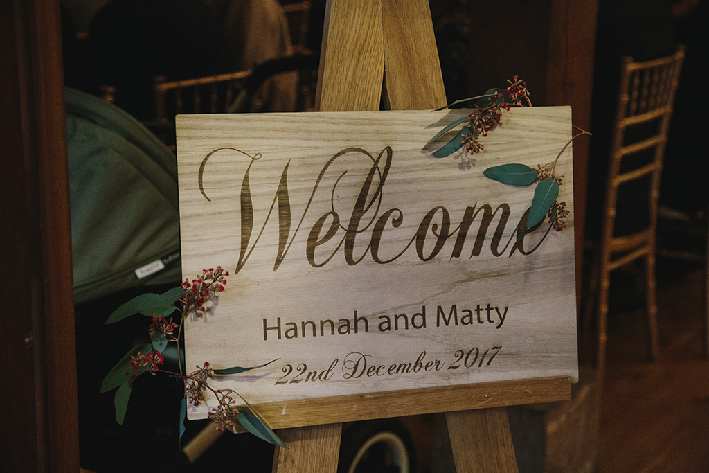 An inviting rustic wooden sign welcomed guests at this barn venue in Cheshire