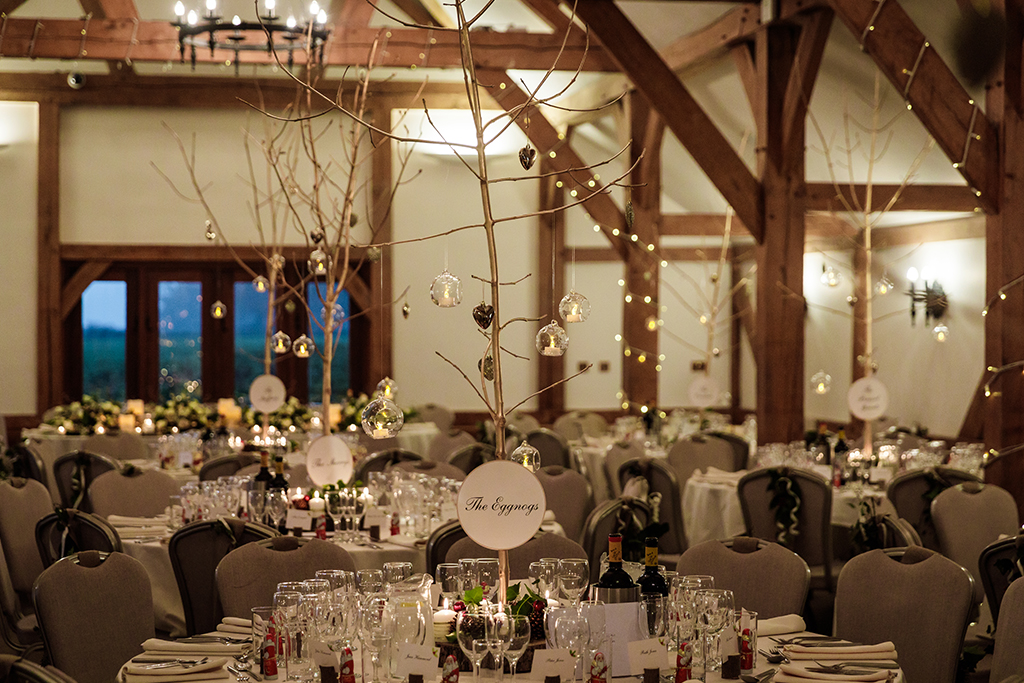 The happy couple pose for an evening wedding photo on the verandah at Sandhole Oak Barn